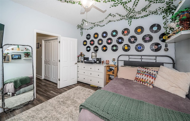 bedroom featuring dark hardwood / wood-style floors, a closet, and ceiling fan