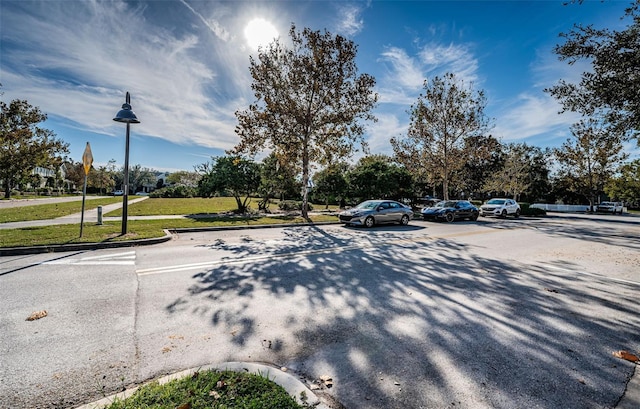 view of car parking featuring a lawn