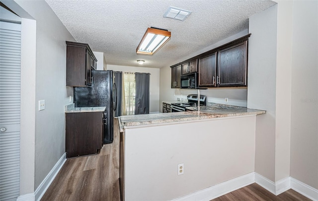 kitchen with dark brown cabinets, black appliances, light hardwood / wood-style flooring, and kitchen peninsula