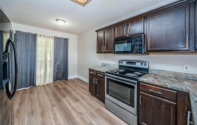 kitchen featuring light stone countertops, black appliances, light hardwood / wood-style flooring, and dark brown cabinetry