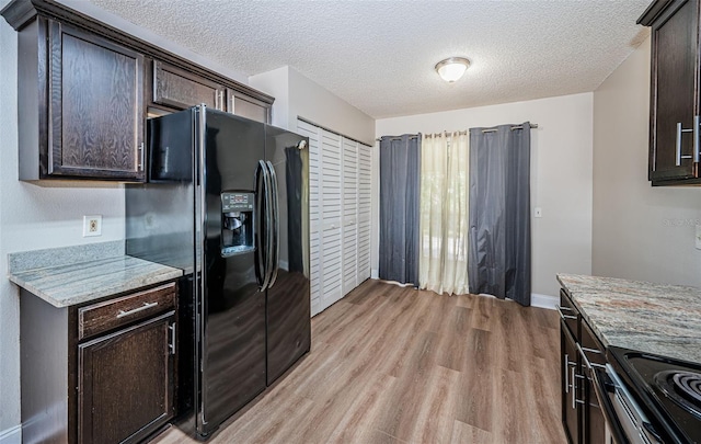 kitchen with light hardwood / wood-style floors, dark brown cabinetry, light stone countertops, and black fridge with ice dispenser