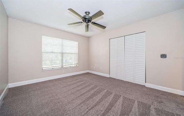 unfurnished bedroom featuring a closet, carpet, and ceiling fan