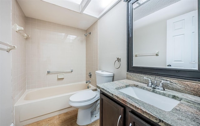 full bathroom featuring toilet, tiled shower / bath combo, vanity, and wood-type flooring