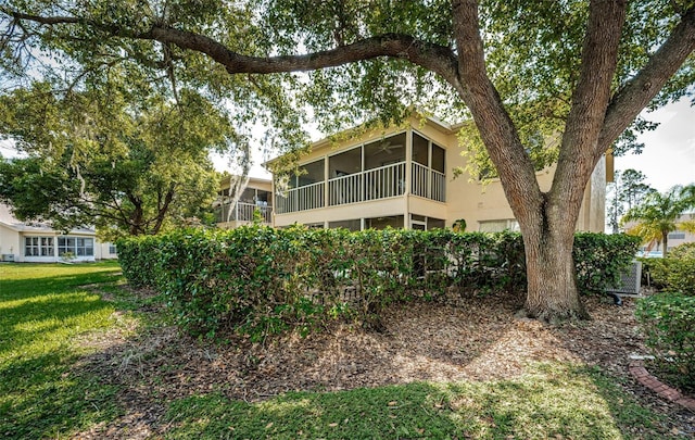 back of property with a sunroom