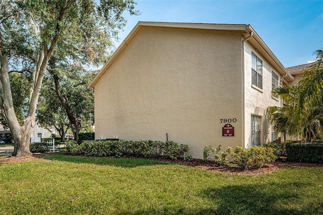 view of side of home with a lawn