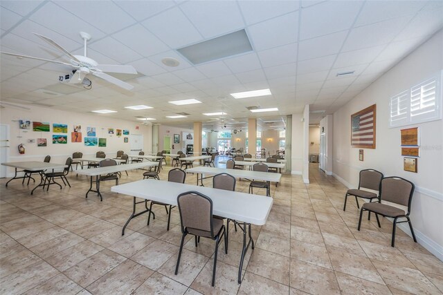 tiled dining room featuring a paneled ceiling and ceiling fan