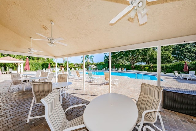 view of swimming pool featuring a patio area and ceiling fan