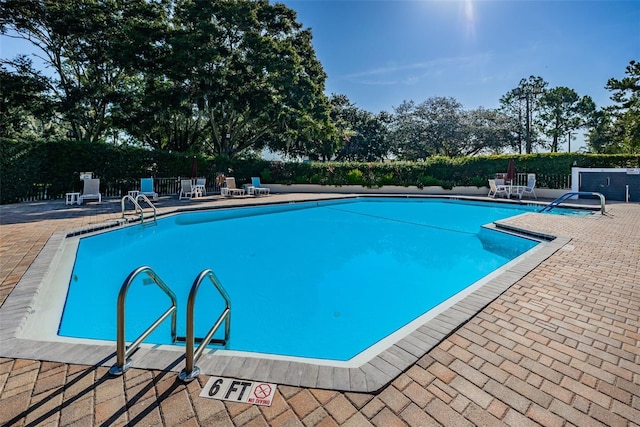 view of swimming pool featuring a patio area