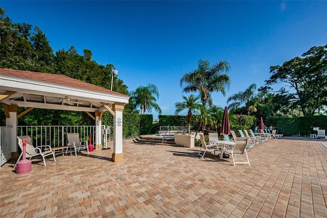 view of patio / terrace featuring a gazebo and ceiling fan