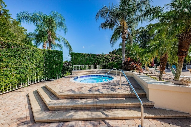 view of swimming pool featuring an in ground hot tub and a patio