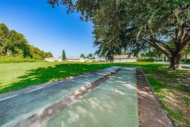 view of home's community featuring a lawn