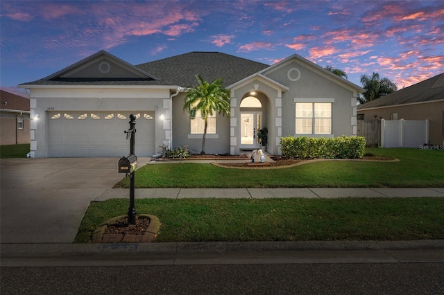 single story home with a yard and a garage