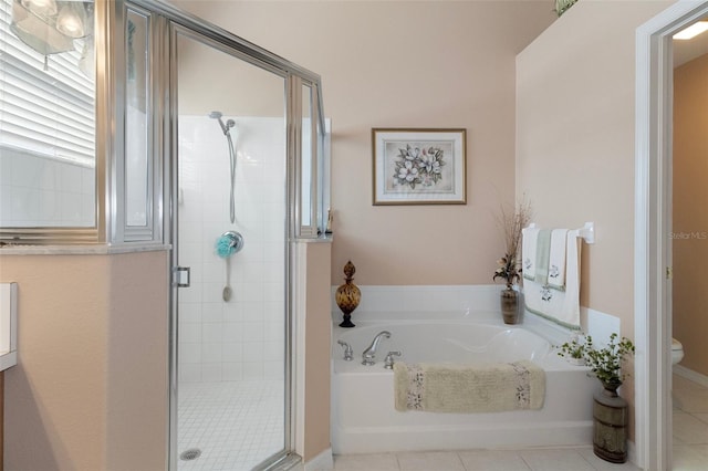 bathroom featuring toilet, tile patterned floors, and plus walk in shower