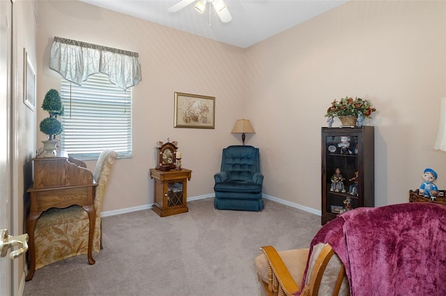 sitting room with light colored carpet and ceiling fan