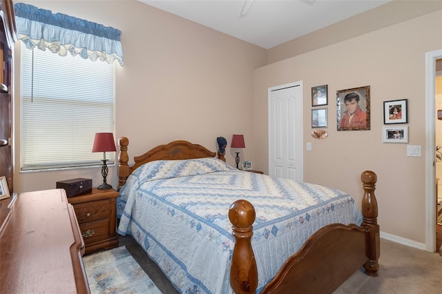 carpeted bedroom featuring a closet and ceiling fan