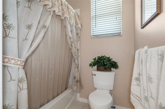 bathroom with toilet, tile patterned floors, and shower / tub combo