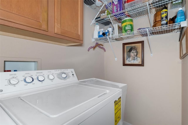 clothes washing area featuring washer hookup and cabinets