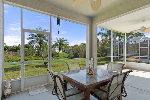 sunroom with a healthy amount of sunlight and ceiling fan