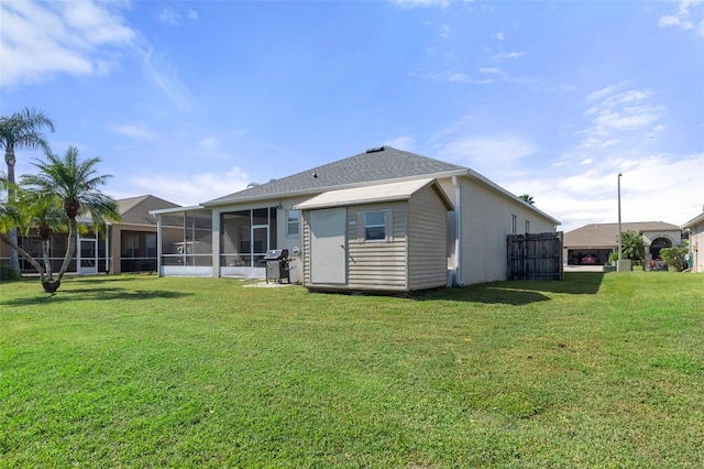 back of property featuring a sunroom and a lawn