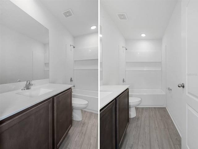 full bathroom with shower / washtub combination, vanity, wood-type flooring, and toilet