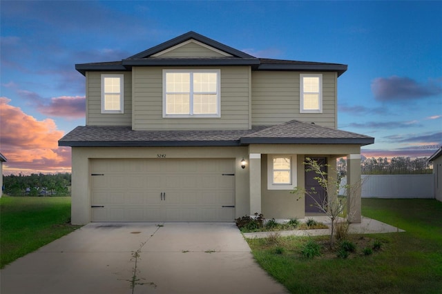 view of front property featuring a garage and a lawn