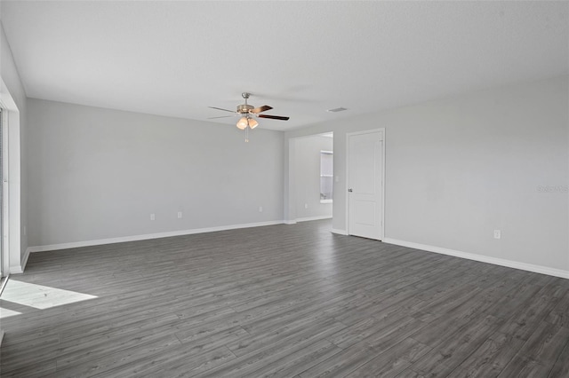 unfurnished room with ceiling fan and dark hardwood / wood-style floors