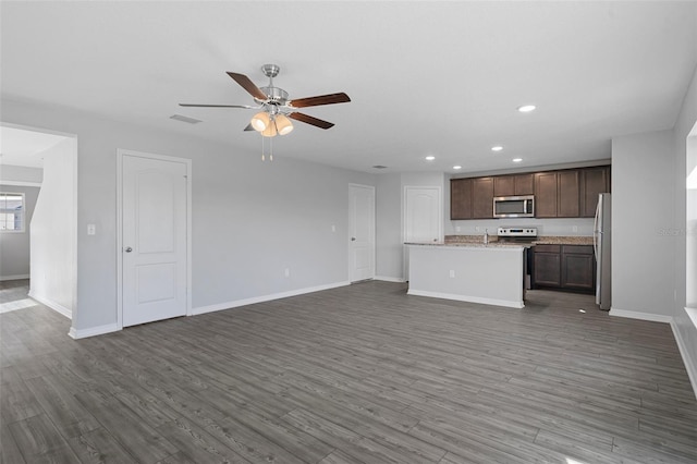 unfurnished living room with dark hardwood / wood-style floors, ceiling fan, and sink