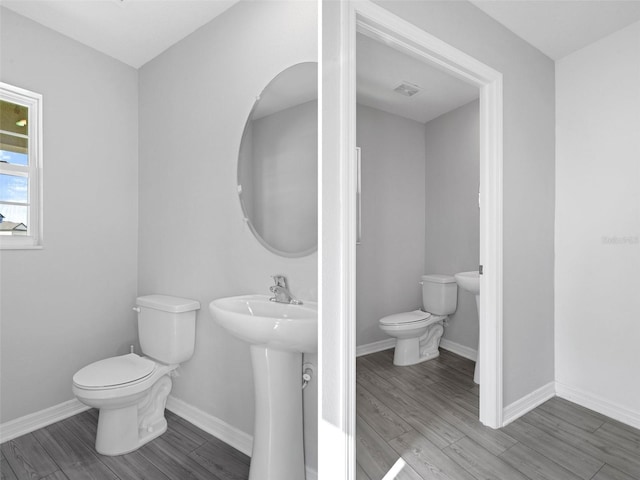 bathroom with sink, toilet, and hardwood / wood-style flooring