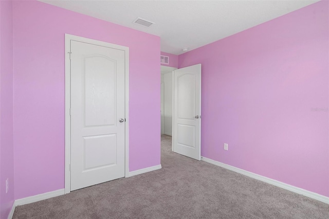 unfurnished bedroom featuring light colored carpet