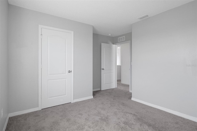 unfurnished bedroom with light carpet