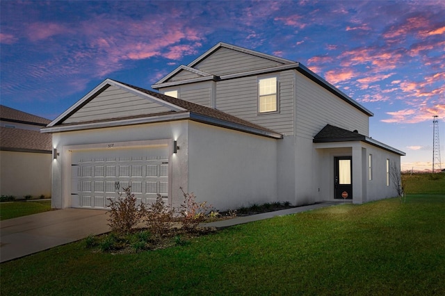 view of front of house featuring a lawn and a garage