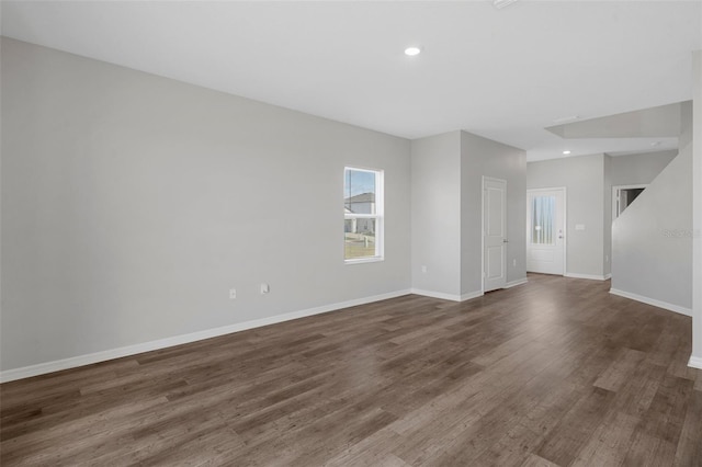 spare room with dark hardwood / wood-style flooring