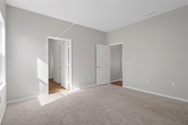 unfurnished bedroom with light carpet