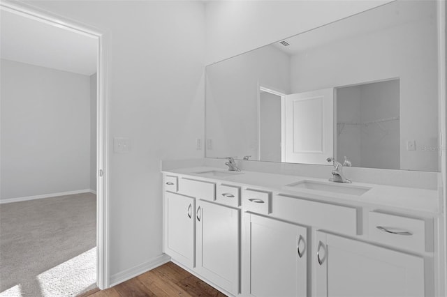 bathroom with hardwood / wood-style floors and vanity