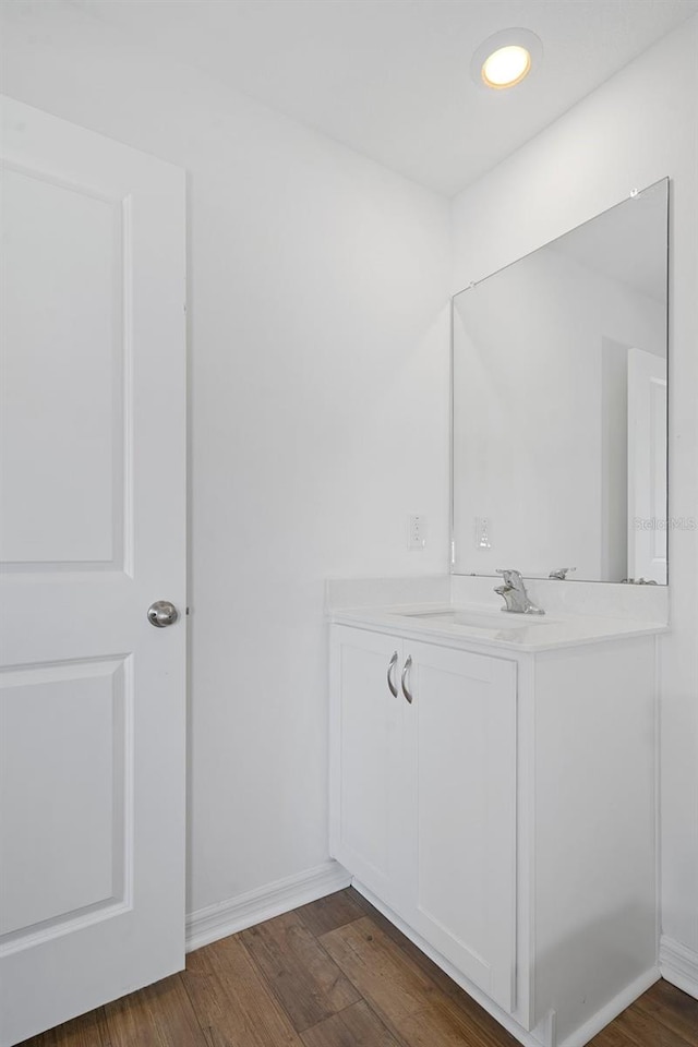 bathroom with vanity and hardwood / wood-style flooring