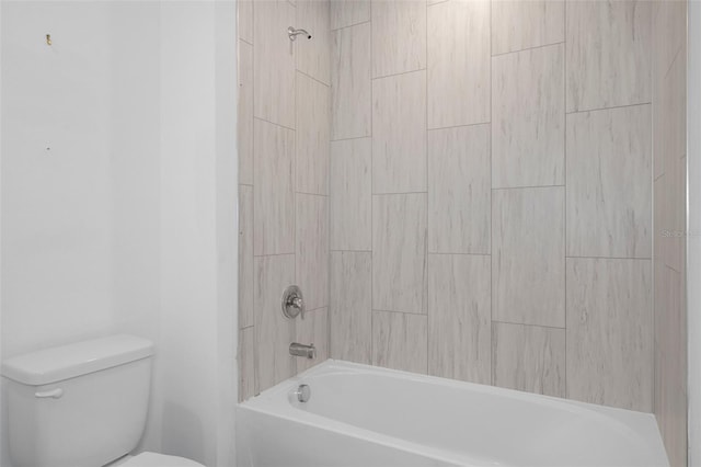 bathroom with tiled shower / bath combo and toilet