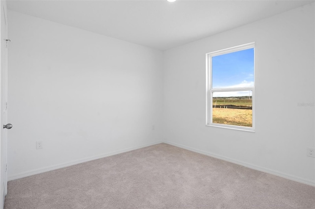 unfurnished room with light colored carpet