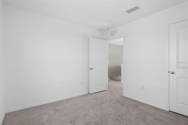 unfurnished room with light colored carpet