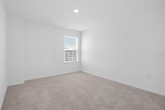 unfurnished room with light colored carpet