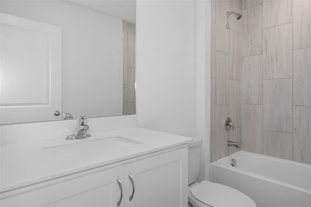 full bathroom featuring toilet, vanity, and tiled shower / bath combo