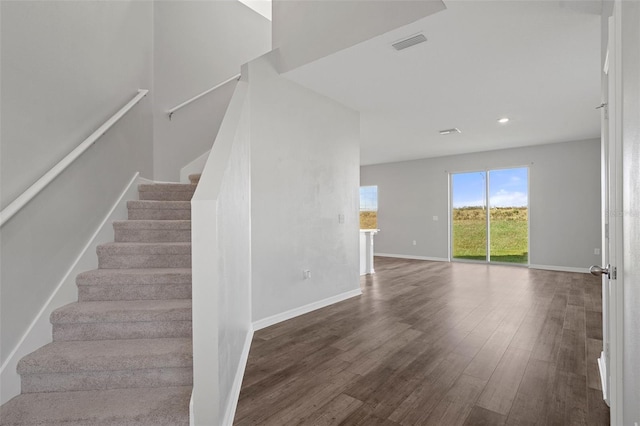 staircase featuring hardwood / wood-style floors