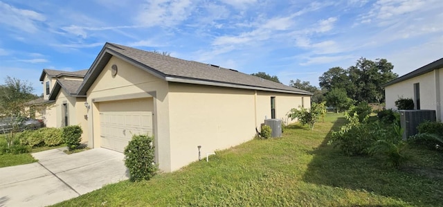 view of side of home with a yard, a garage, and central AC unit