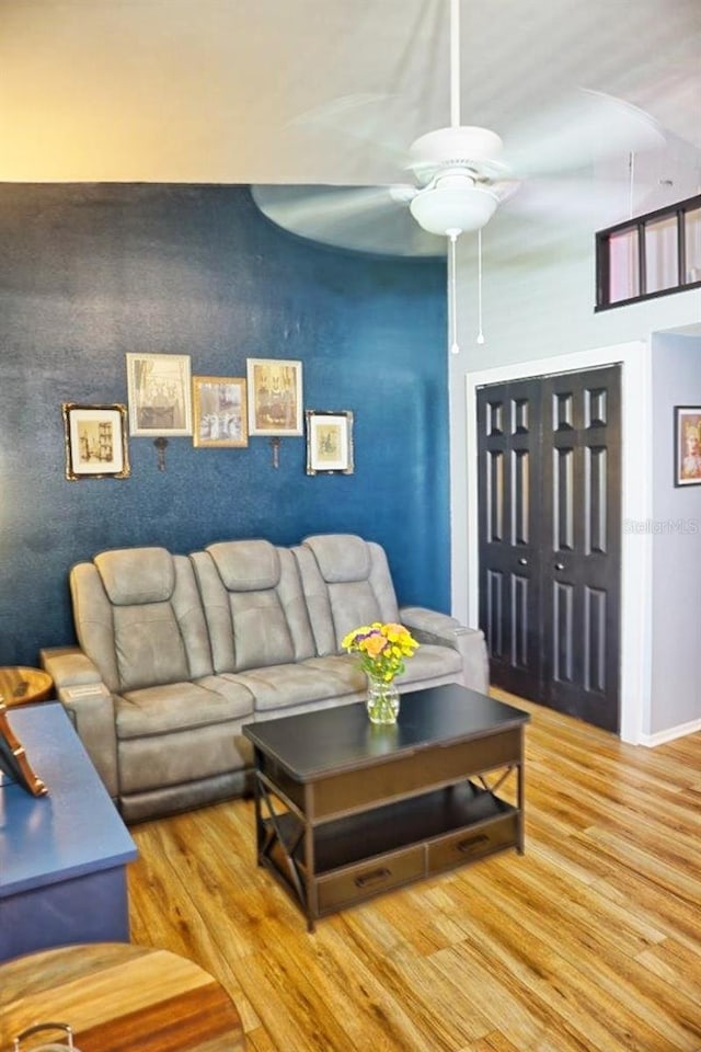 living room featuring ceiling fan and wood finished floors
