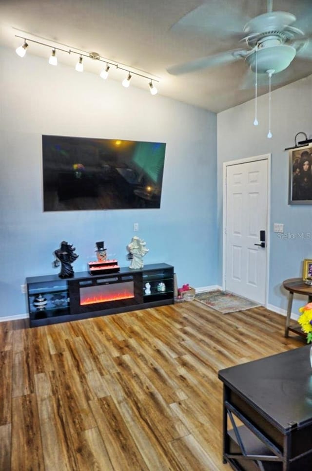 living room with hardwood / wood-style flooring and ceiling fan