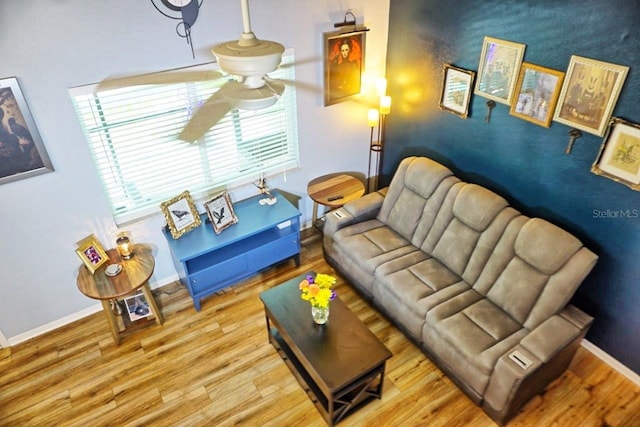 living room featuring hardwood / wood-style flooring and ceiling fan