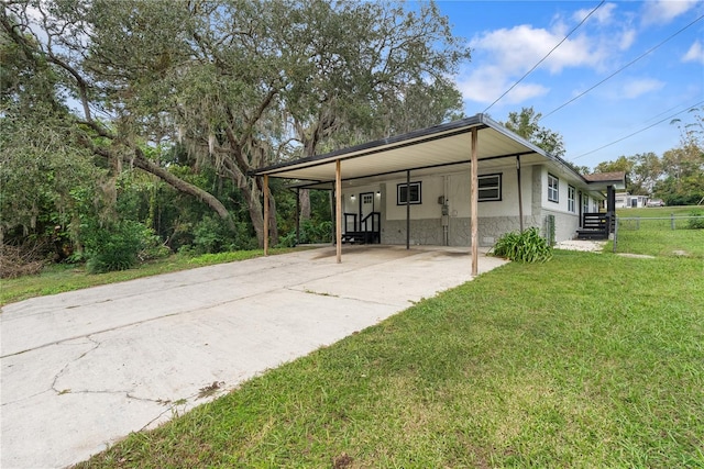 back of house featuring a yard and a carport