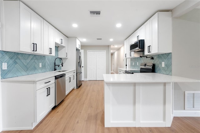 kitchen with white cabinetry and appliances with stainless steel finishes