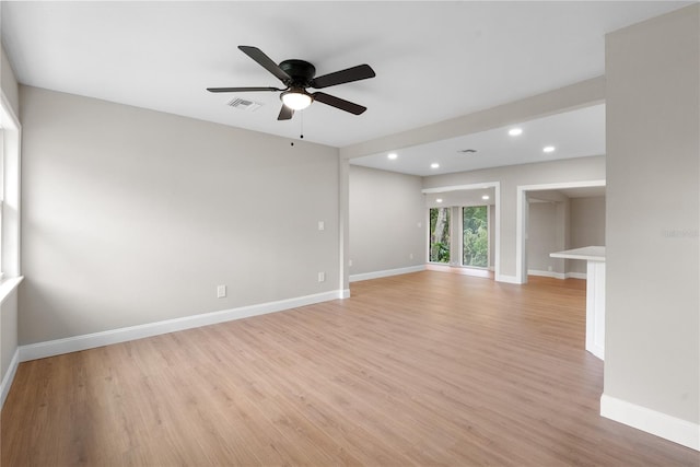 unfurnished living room with ceiling fan and light wood-type flooring