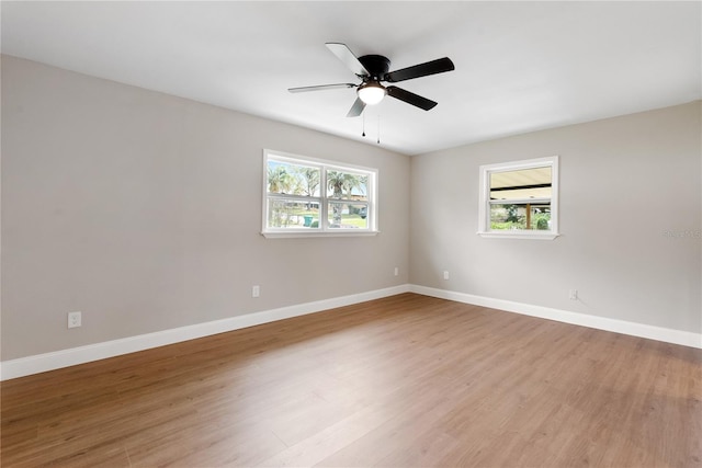 unfurnished room with light wood-type flooring and ceiling fan