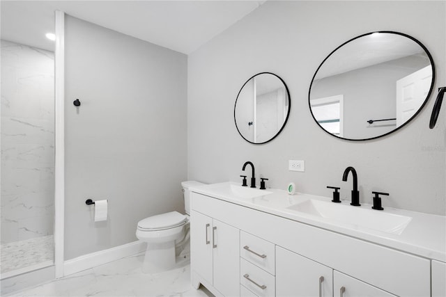 bathroom with toilet, vanity, and tiled shower